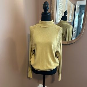 Free people, turtleneck, banded, bottom sweater.